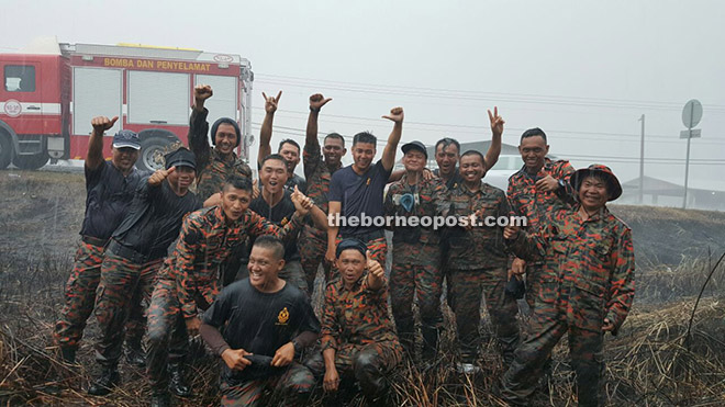 Firefighters who have been battling fires in Papar, were relieved and overjoyed as they cool off in the rain after battling bush and forest fire since the El Nino dry spell. 