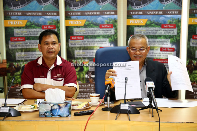 Talib displays the participation form at the press conference. On his right is Ik Pahon Joyik, the permanent secretary of Tourism Ministry.