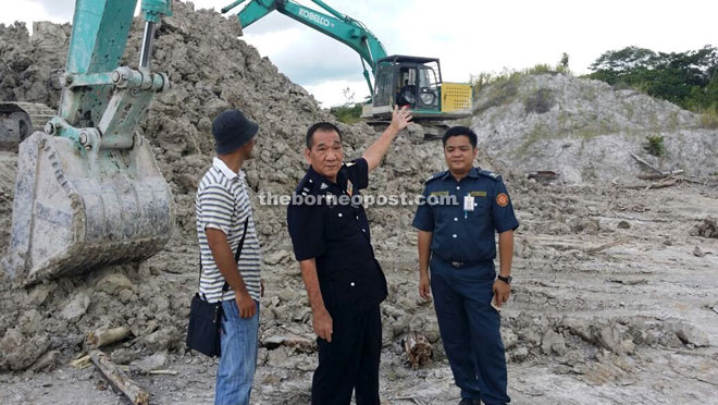 Kuching GOF Battalion 11 commander Supt Soh Hock Sing gestures towards one of the excavators that was used to steal the clay.