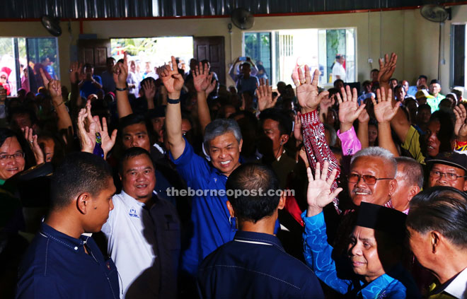 (From second left) Abdul Yakub and Zahid wave to the people upon arriving for the event.