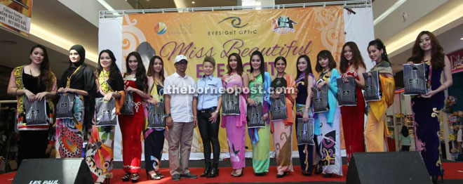 Finalists of Miss Cultural Harvest Festival 2016 in a photo-call with festival director Zaini Zainuddin (sixth left) and Eyesight Optic branch manager Lily Sim (seventh left) after the Miss Beautiful Eyesight showcase at Summer Mall.