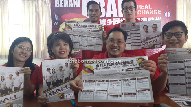 Chong (seated second right) and other candidates show the DAP manifesto at the press conference.