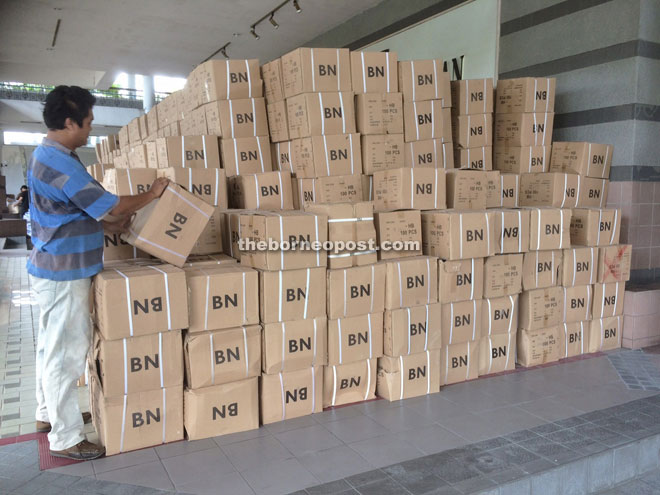A party worker staking up boxes of election materials at PBB headquarters in Kuching yesterday. — Photo by Peter Sibon