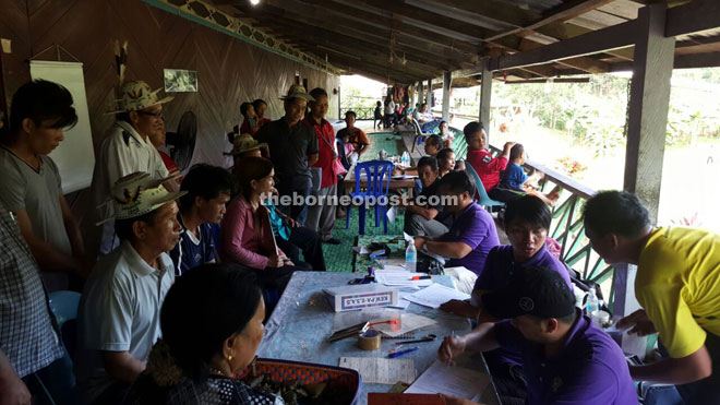 Some villagers from Long Busang applying for their personnel documents when NRD officers went to the Kenyah village recently, with the assistance of Liwan. 