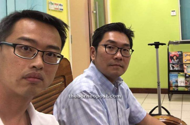 Sim (right) and Lee at KIA Immigration office. — Photo courtesy of Sim’s Facebook account.