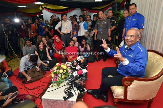 Adenan showing the victory sign to photographers after meeting the press at a meet the press session held at the Old State Legislative Assembly last night. 