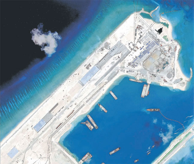 This file handout photo taken on April 2, 2015 by satellite imagery provider DigitalGlobe and released to AFP by the Asia Maritime Transparency Initiative department at the Center for Strategic and International Studies (CSSI) think tank shows a satellite image of what is claimed to be an under-construction airstrip at Fiery Cross Reef in the Spratly Islands in the disputed South China Sea. — AFP photo