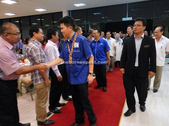 Chong (wearing BN shirt) greets those coming for the dinner. Behind him, also wearing a BN shirt, is Henry.