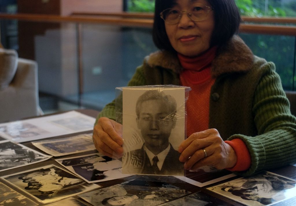 Hsu Hsu-mei holds a portrait of her father Hsu Chiang, taken away and executed on espionage charges during the 'White Terror' political purge by Taiwan's ruling Kuomintang (KMT).-AFP Photo