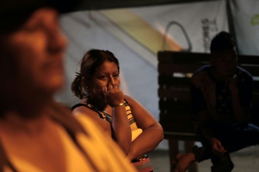 People outside their home in Manta, Ecuador after an earthquake struck in the early morning on May 18, 2016 -AFP