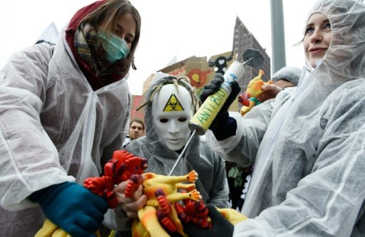 Protesters perform with a fake chicken and syringe labelled "antibiotics" during a demonstration in Berlin against industrial farming -AFP photo