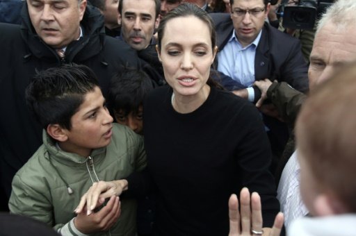 UN special envoy Angelina Jolie Pitt (C) visits refugees during her visit to the Greek port of Piraeus in March 