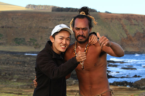 Kong with islander Mia who lives in the traditional lifestyle of Easter Island by catching fish, growing crops, and dressing the old way – Ahu Tongariki on Easter Island, Chile.