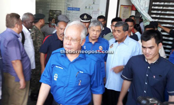 (Facing camera, from left) Najib, Deputy Prime Minister Datuk Seri Dr Ahmad Zahid Hamidi and Khalid are seen leaving the SGH mortuary.