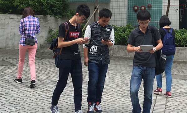 Smartphone zombies move around glued to their gadgets.