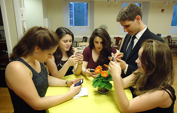 Young people texting on smartphones.