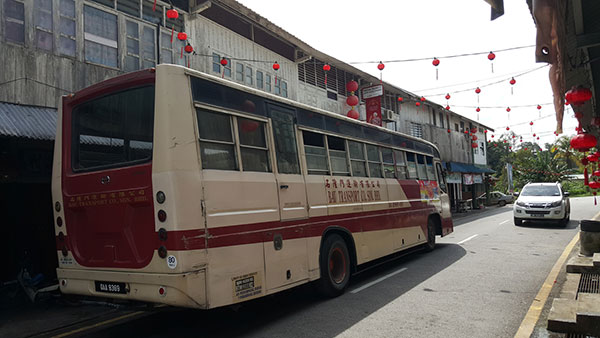 Bau Transport Company bus passes through the narrow Siniawan street.