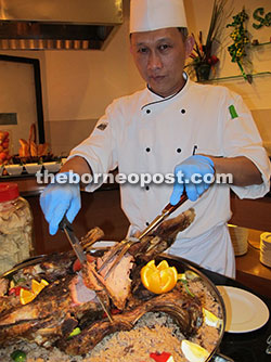 Hilton Kuching banquet chef Muhammadiah Ali slices the meat off a whole lamb roast.