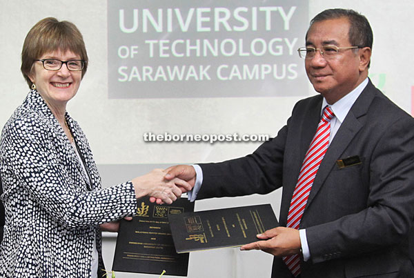 Gregory and Grunsin shake hands after signing the MOA.