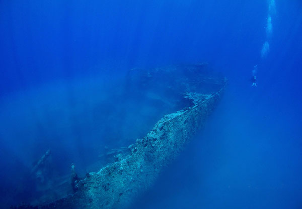 A diver is dwarfed by the giant stern of the wreck in this photo taken April 27, 2014. Divers who visited the wreck last Sunday said that section had been destroyed.