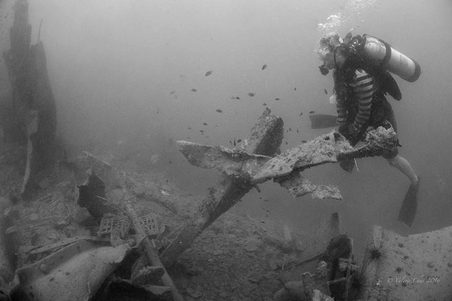 A diver surveys a forlorn landscape of twisted metal structures, debris and rubble – all that is left of the WWII Japanese shipwreck Katori Maru after it was targetted by rogue metal salvag-ers last March. 