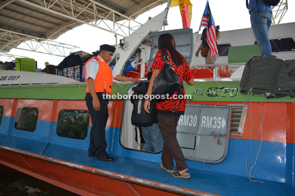 A SRB officer looks on as passengers embark. 