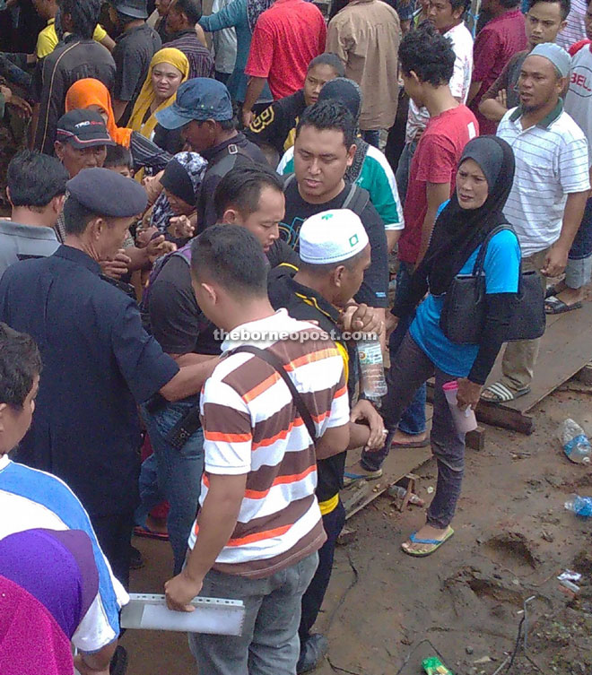 A man being calmed down by the police.