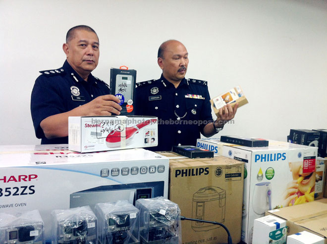 Mohd Kamarudin (right) and another officer show the seized items during a press conference. — Bernama photo