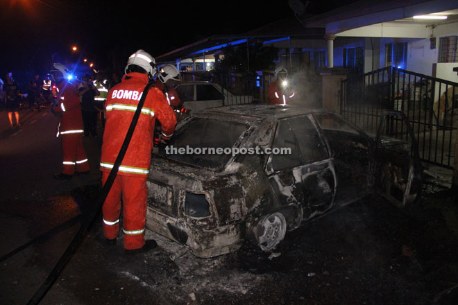 Firemen working at the scene.