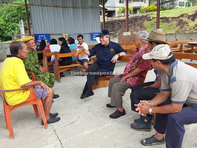 Awang Tengah (fourth right) meets some of the residents in Long Luping during a brief stop-over enroute to Buduk Nur.