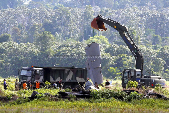 Workers can be seen clearing the wreckage of Royal Malaysian Air Force Aermacchi MB339CM jet. — Bernama photo