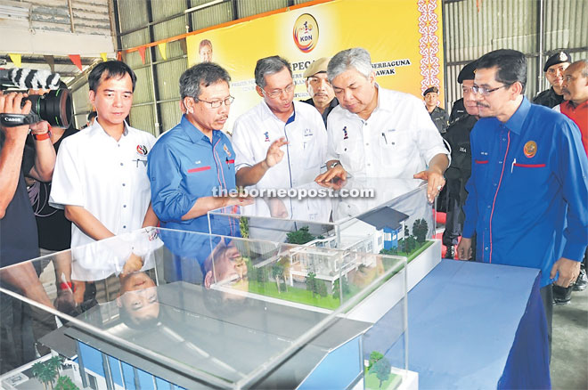 Zahid (second right) looks at the model of the new quarters to be built at 10th Battalion GOF at Lanang Camp.