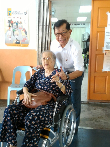 Datuk Patinggi Tan Sri Dr George Chan with his mother Leong Lee Hua at SJK Chung Hua Polling Station. She is exercising her right to vote and do the right thing. She is 101 years old.