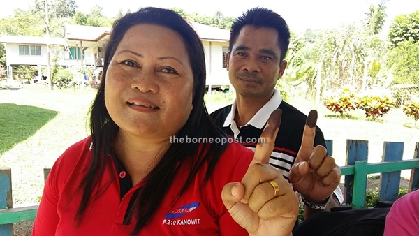 Tuai Rumah Andrew Karani (right) and his wife Rosalind Galan showing their index finger after casting their ballots at polling centre SK Nanga Ngungun, Kanowit. They are among a total of 8,899 voters in Ngemah. Ngemah has six polling districts namely Bat, Kajah, Sengayan, Mapai, Bawan and Pedai.