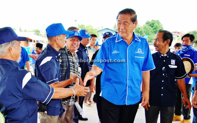 Pau shakes hands with locals upon arriving at the community hall for the gathering