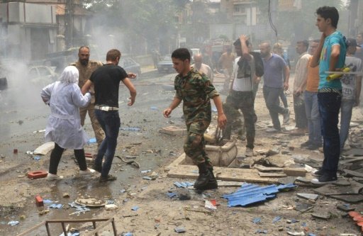 Syrian security forces evacuate medical staff after rockets reportedly fired by rebels hit Al-Dabbeet hospital in the government-controlled neighbourhood of Muhafaza in the northern city of Aleppo on May 3, 2016 -AFP