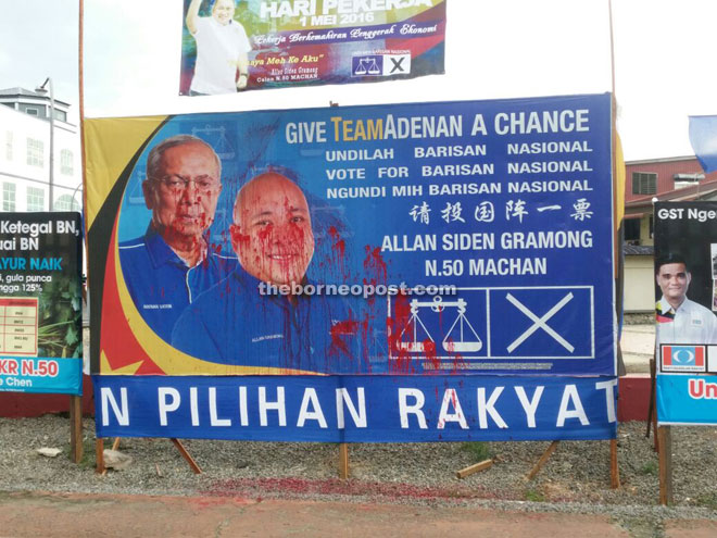 The poster at Access Road smeared with red paint.