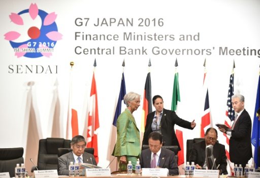 IMF Managing Director Christine Lagarde (top, C) walks behind Governor of the Bank of Japan Haruhiko Kuroda (L) and Japanese Finance Minister Taro Aso (C) prior to the start of the G7 meeting in Sendai on May 20, 2016. Photo by AFP