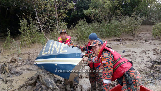 Rescuers show a part of the helicopter debris.