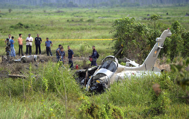 The RMAF Aermacchi MB339CM plane wreckage lying on the field at Kampun Pandan Dalam, Pekan. — Bernama photo
