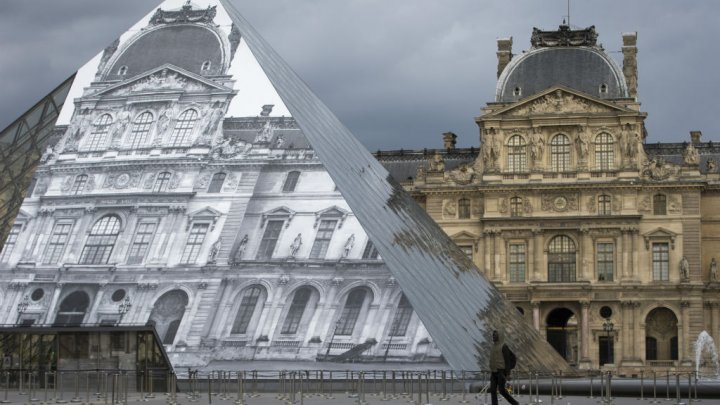 The Louvre Pyramid covered with a giant photograph of the museum by French artist and photographer JR shown on May 19. Photo by AFP