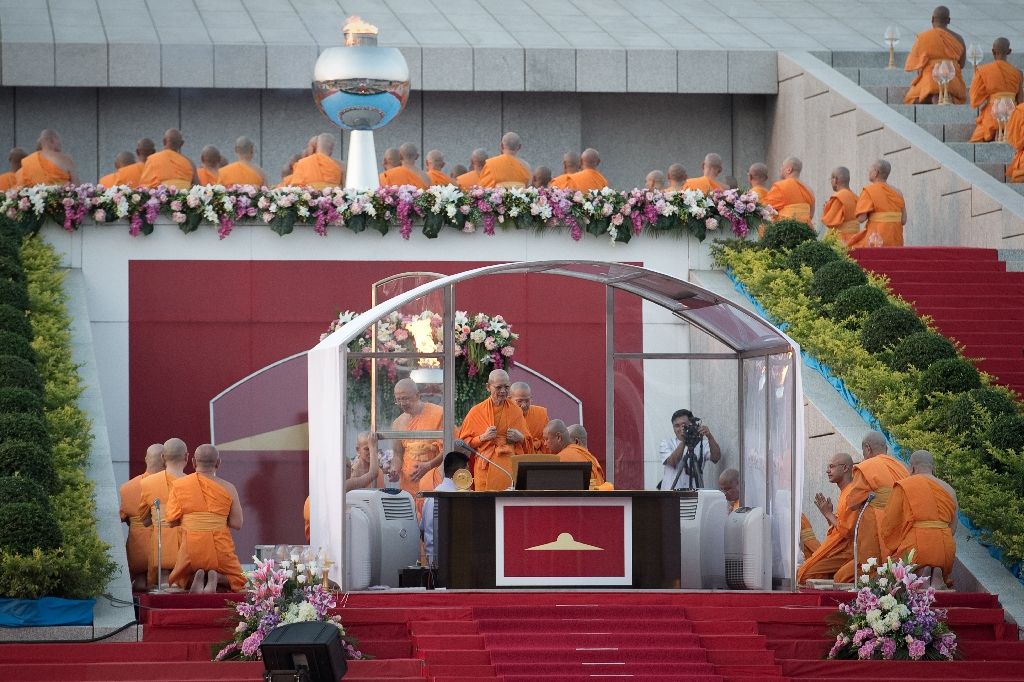 Phra Dhammachayo (centre), abbot of the Dhammakaya Temple and founder of the Dhammakaya Foundation, leads a religious ceremony at the temple in Bangkok. Photo by AFP