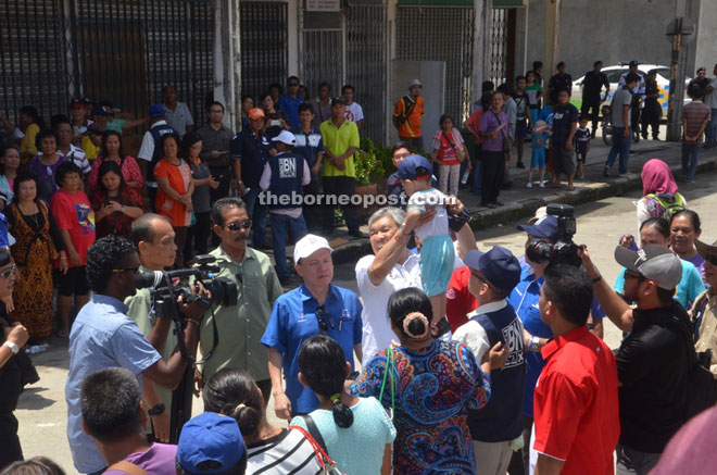 Zahid (left) mingles with the people in Selangau. 