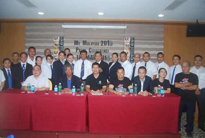 Kamaruzaman (seated second left) with others at a press conference.