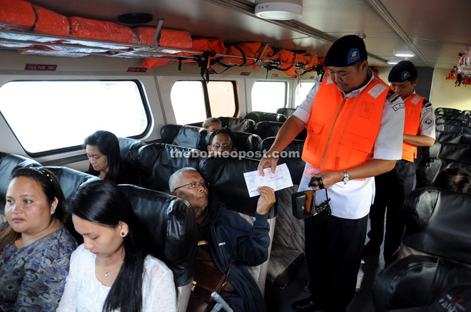 SRB assistant enforcement officer Jerry Lenggir checks passengers for tickets to prevent overloading. 