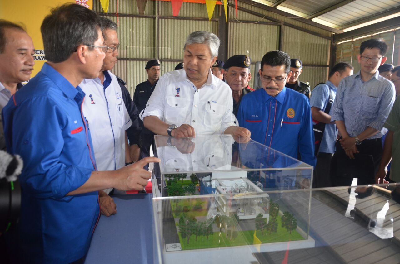 Ahmad Zahid (third left) looking at the model of the new quarters to be built at 10th Battalion GOF base at Lanang Camp in Sibu.