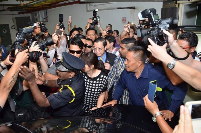 Lim swarmed by members of the media as he is taken under custody. -Photo credit Oriental Daily News.