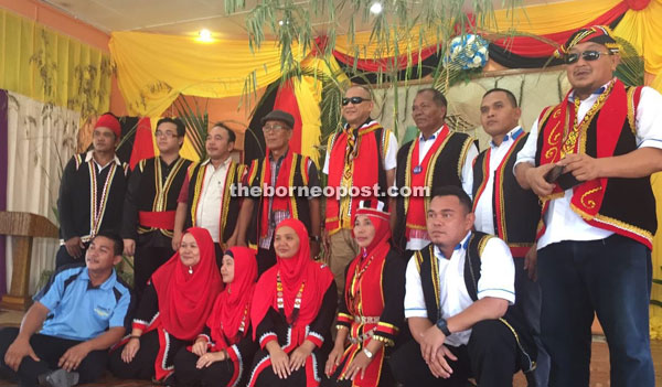 Nazri, standing fourth from right, in a photo call with Kampung Belimbing Padawan residents yesterday.