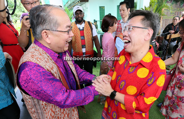 Uggah (left) shares a joke with Dr Sim. 