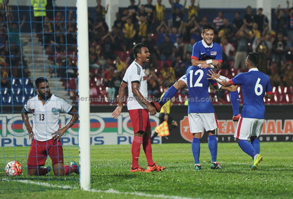 Malaysia’s Ahmad Bakri (number 12) celebrates with teammates after scoring against Timor Leste at Stadium Tan Sri Hassan Yunos Larkin on Thursday. — Bernama photo 